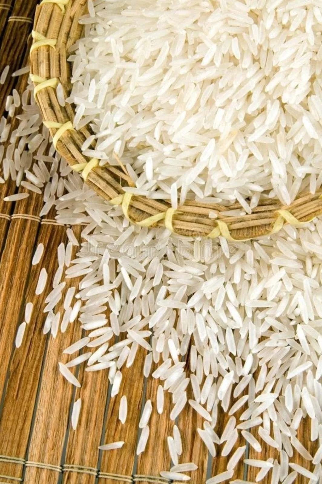 Rice grains spilling from a woven bamboo basket